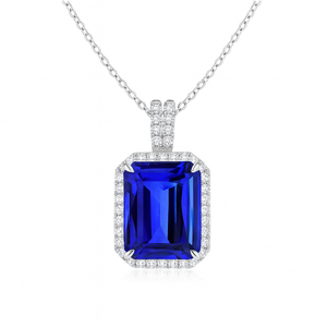 Emerald-cut tanzanite pendant with diamond halo in 14K gold setting, featuring an 18-inch chain.