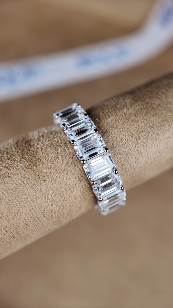 6 Carat Emerald-Cut Lab-Grown Diamond Eternity Ring on display highlighting its architectural elegance.