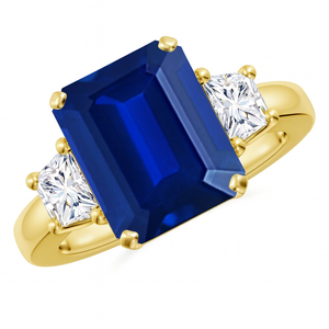 Emerald-cut blue sapphire three stone ring in 14K gold by Irdoja Diamonds, featuring a 5-carat center stone.