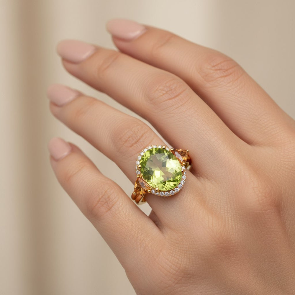 Oval peridot center stone with trillion citrine accents and diamond halo in 18k white gold ring by Irdoja Diamonds.