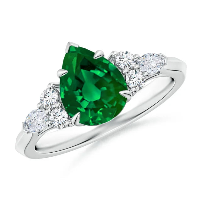 Pear shape lab-grown emerald engagement ring with diamond side stones in 18k white gold by Irdoja Diamonds.