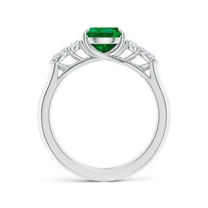 Lab-grown pear shape emerald engagement ring with diamond side stones in 18k white gold by Irdoja Diamonds.