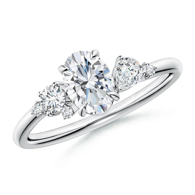 Claw prong oval lab-grown diamond engagement ring in 18k white gold with multi-shape diamond accents.
