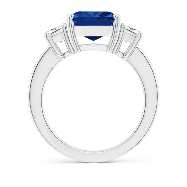 Emerald-cut blue sapphire three stone ring in 14K white gold by Irdoja Diamonds.