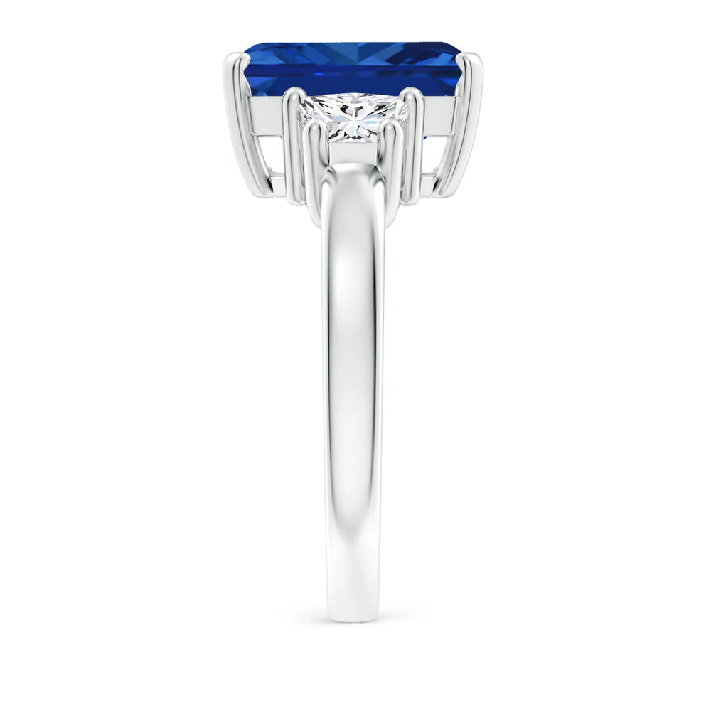 Emerald-cut blue sapphire three stone ring in 14K white gold by Irdoja Diamonds.