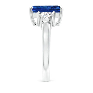 Emerald-cut blue sapphire three stone ring in 14K white gold by Irdoja Diamonds.