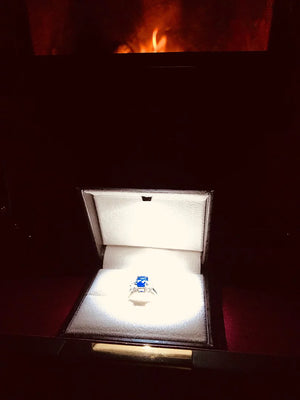 Emerald-cut blue sapphire three stone ring in 14K or 18K gold by Irdoja Diamonds, displayed in an elegant box.