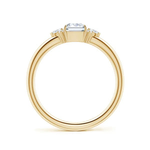 Four-claw prong emerald-cut lab-grown diamond engagement ring in 18k yellow gold with marquise diamond accents.