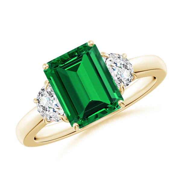 Emerald-cut lab-grown emerald three stone ring with half moon diamonds in 14k gold by Irdoja Diamonds.