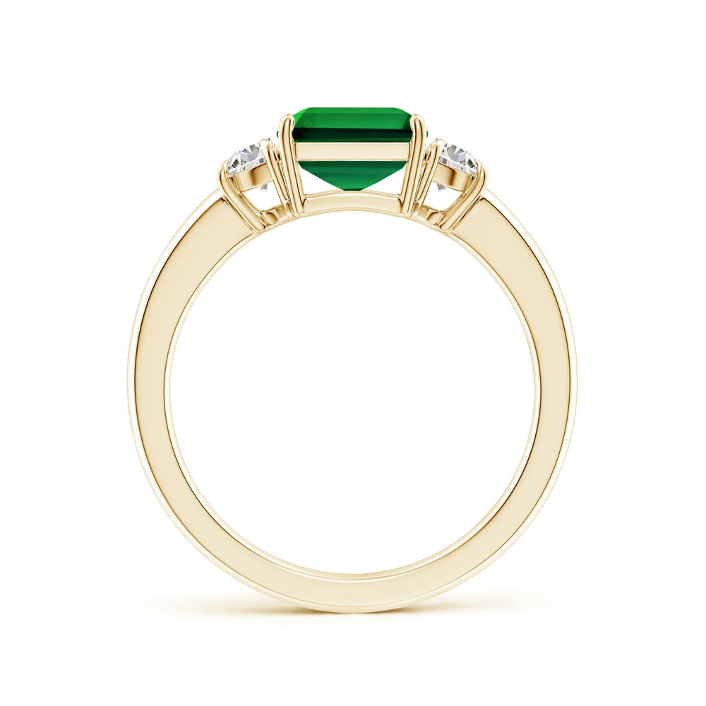 Emerald-cut lab-grown emerald three stone ring with half moon diamonds in 14k gold by Irdoja Diamonds.