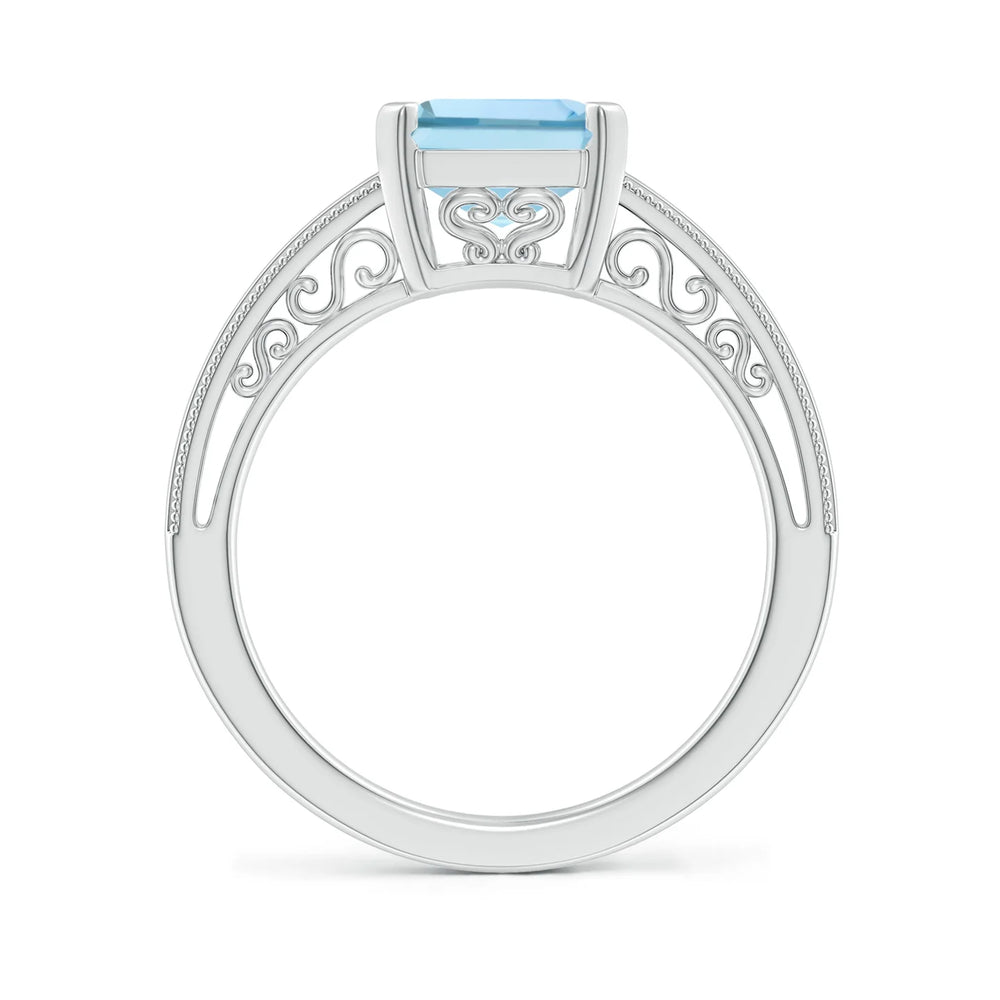 Emerald-cut aquamarine solitaire engagement ring with milgrain detailing by Irdoja Diamonds.