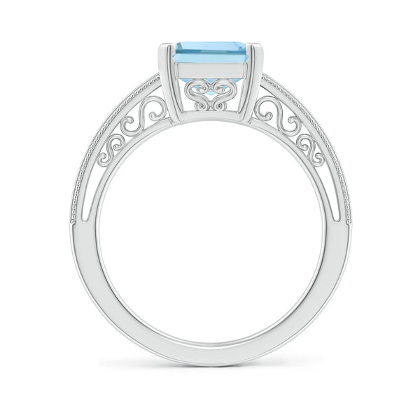 Emerald-cut aquamarine solitaire engagement ring with milgrain detailing in silver by Irdoja Diamonds.