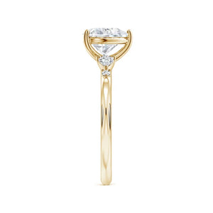 Prong-set heart-shaped lab-grown diamond engagement ring with side stones in a yellow gold band by Irdoja Diamonds.
