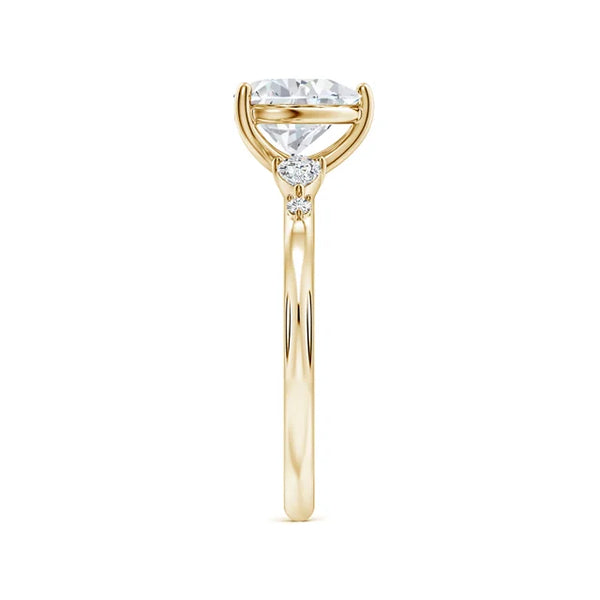 Prong-set heart-shaped lab-grown diamond engagement ring with side stones in a yellow gold band by Irdoja Diamonds.