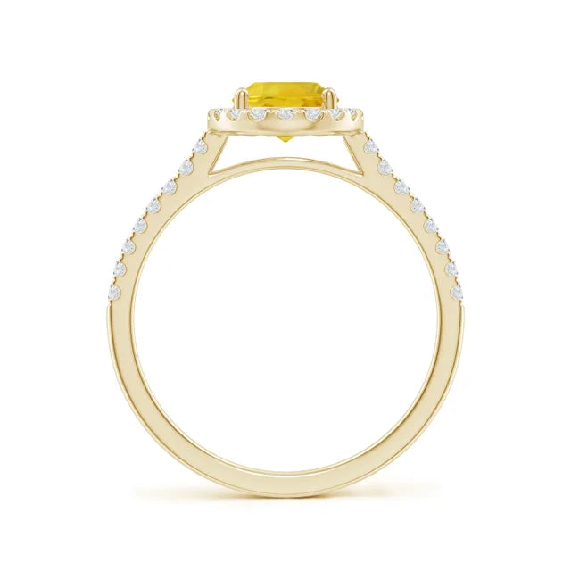 Prong-set oval yellow sapphire halo ring with diamond accents in 14k gold by Irdoja Diamonds.