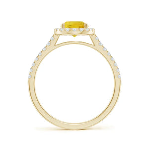 Prong-set oval yellow sapphire halo ring in 14k gold with diamond accents by Irdoja Diamonds.