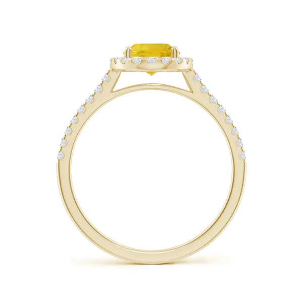 Prong-set oval yellow sapphire halo ring in 14k gold with diamond accents by Irdoja Diamonds.