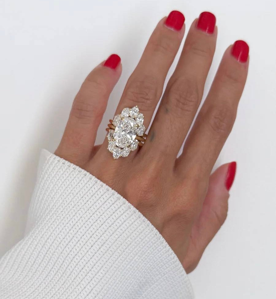 6-carat marquise lab diamond engagement ring set in 18K white gold with interlocking wedding bands.