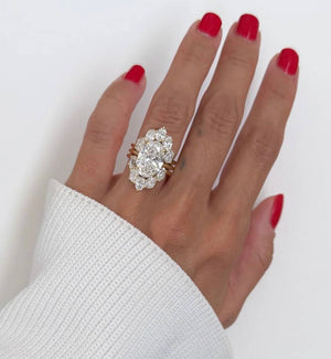6-carat marquise lab diamond engagement ring set in 18K white gold with interlocking wedding bands.
