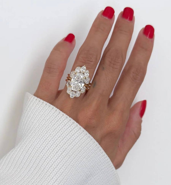 6-carat marquise lab diamond engagement ring set in 18K white gold with interlocking wedding bands.