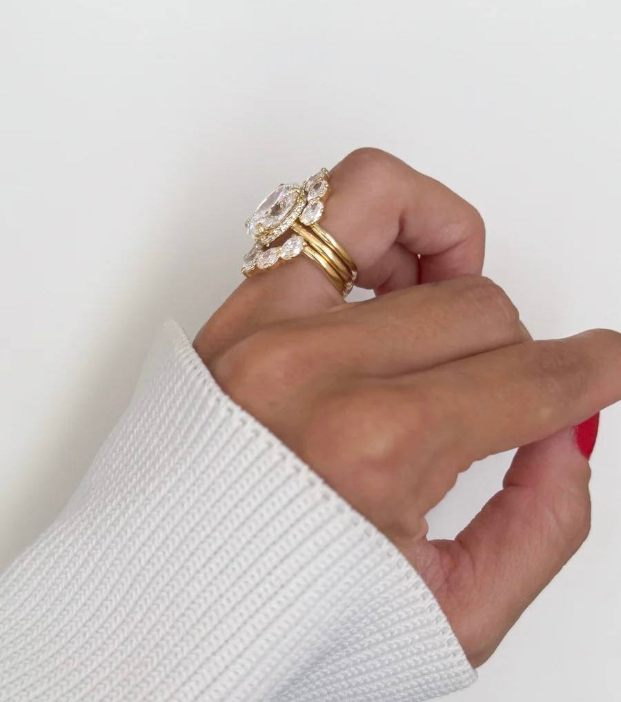 6-carat marquise lab diamond engagement ring set in 18K white gold with interlocking wedding bands.