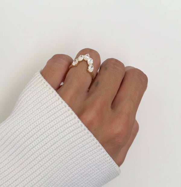 6 carat marquise lab diamond engagement ring set in 18K white gold with interlocking wedding bands.