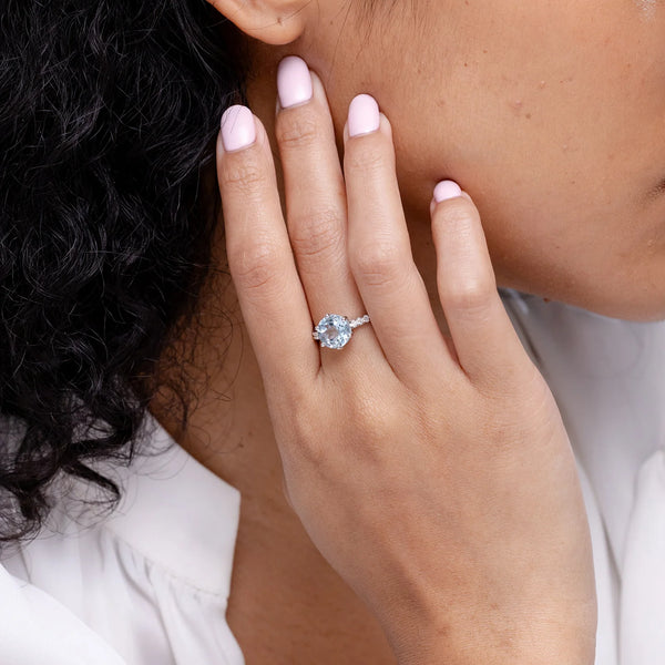 Natural aquamarine solitaire engagement ring with diamond accents in 14K gold by Irdoja Diamonds.