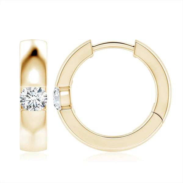 Channel-set round diamond huggie hoop earrings in 18k yellow gold by Irdoja Diamonds.