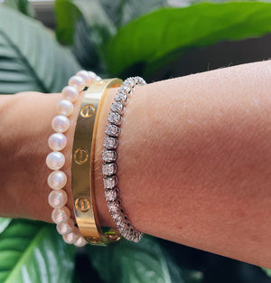 Classic Japanese Akoya Pearl Single Strand Bracelet (14K White Gold) worn with other bracelets on a wrist.