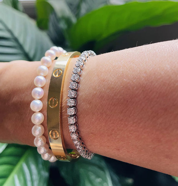 Classic Japanese Akoya Pearl Single Strand Bracelet (14K White Gold) worn with other bracelets on a wrist.