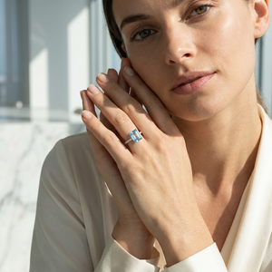 Emerald-Cut Aquamarine Ring with Diamond Band worn by a model, showcasing its icy-blue clarity and luxurious design.