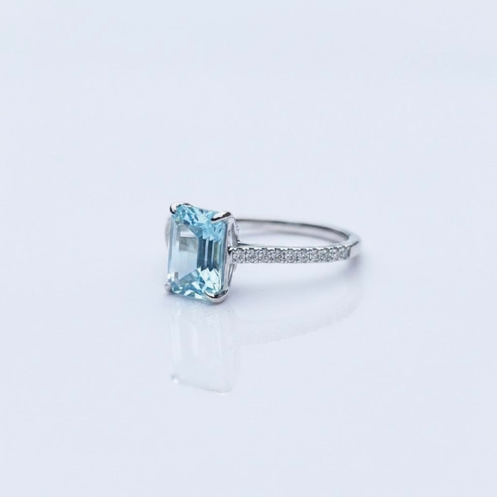 Emerald-Cut Aquamarine Ring with Diamond Band showcasing icy-blue clarity and elegant design.