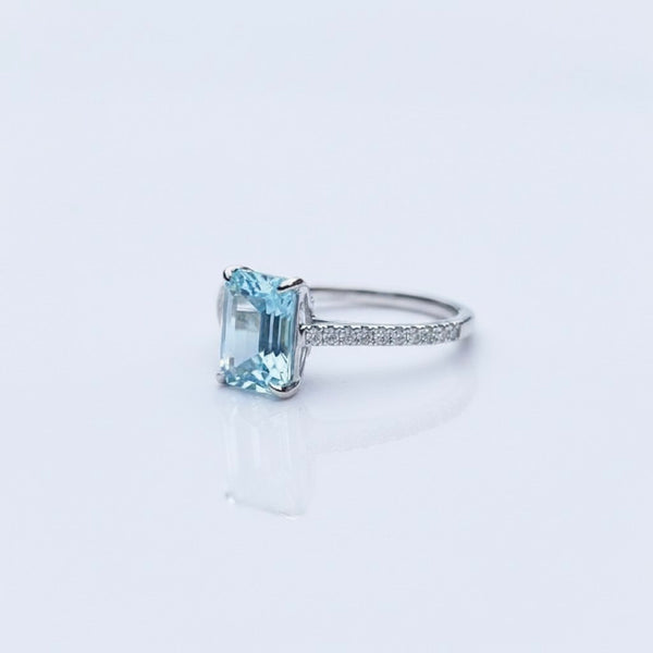 Emerald-Cut Aquamarine Ring with Diamond Band set in white gold, featuring a stunning icy-blue aquamarine center stone.