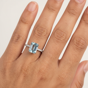 Emerald-Cut Aquamarine Ring with Diamond Band featuring a mesmerizing icy-blue aquamarine center stone.