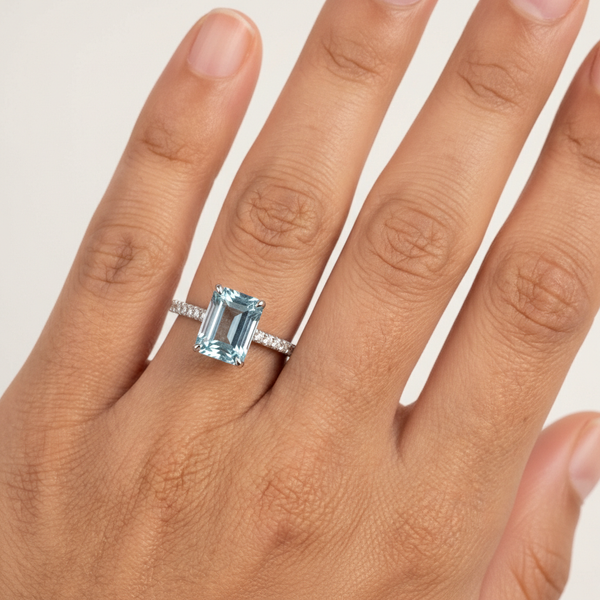 Emerald-Cut Aquamarine Ring with Diamond Band featuring a mesmerizing icy-blue aquamarine center stone.