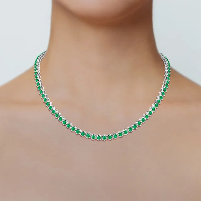 Hexagon emerald tennis necklace in 18K gold, featuring 8-carat AAA emeralds set in a delicate bezel design.