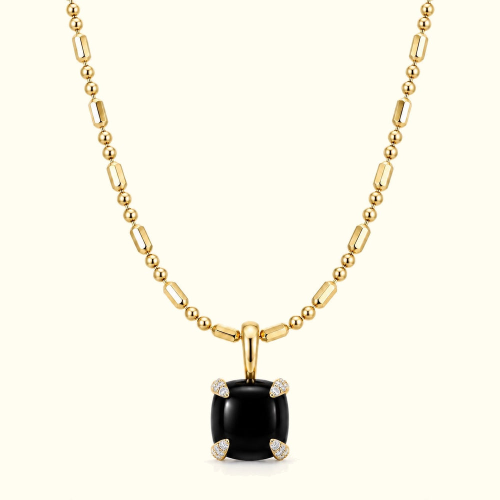 Bloom amulet necklace, a black onyx pendant on a 14K yellow gold ball-and-bar chain
