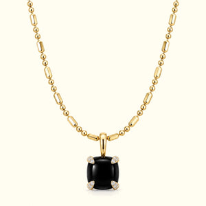 Bloom amulet necklace, a black onyx pendant on a 14K yellow gold ball-and-bar chain