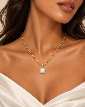 Bloom amulet necklace in mother of pearl, worn