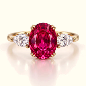 The Rose Tourmaline Ring in yellow gold, a 2.50ct oval pink tourmaline between two pear-cut lab diamonds