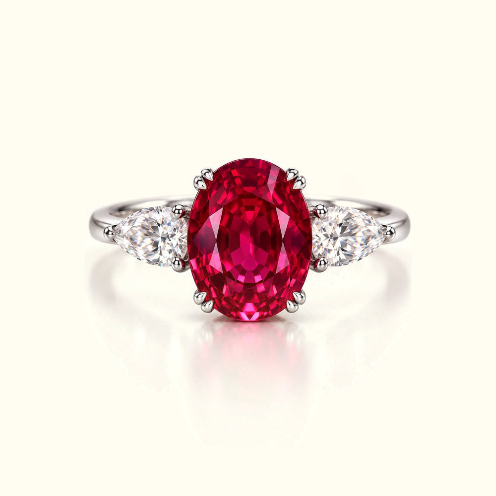 The Rose Tourmaline Ring, a 2.50ct oval lab-grown pink tourmaline between two pear-cut lab-grown diamonds in platinum