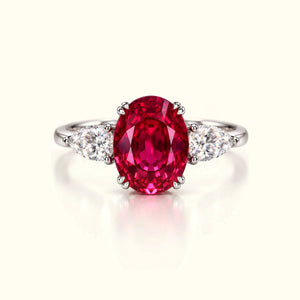 The Rose Tourmaline Ring, a 2.50ct oval lab-grown pink tourmaline between two pear-cut lab-grown diamonds in platinum