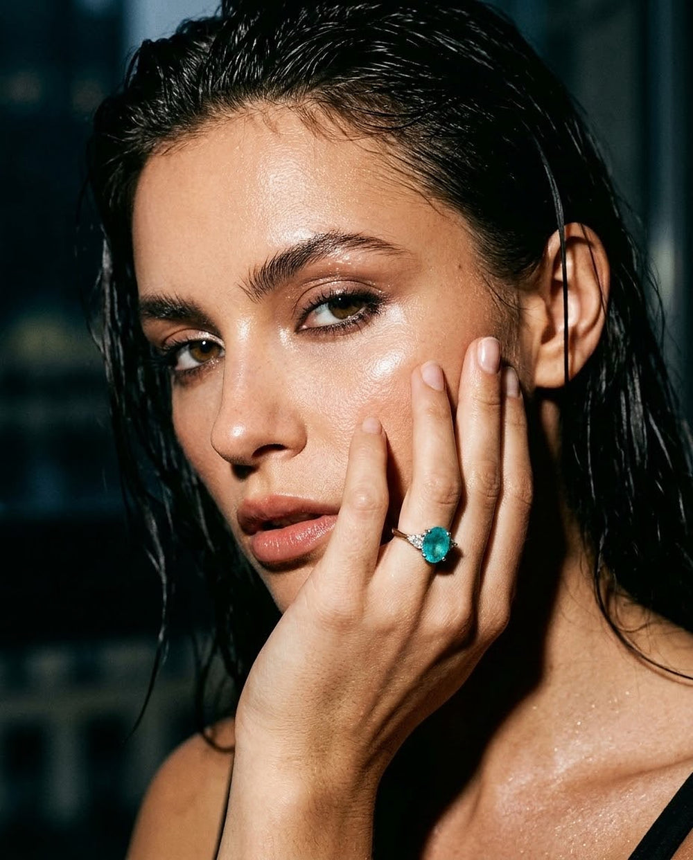 The Azure Paraiba Ring, an oval Paraiba tourmaline with trillion-cut diamonds in 18K white gold