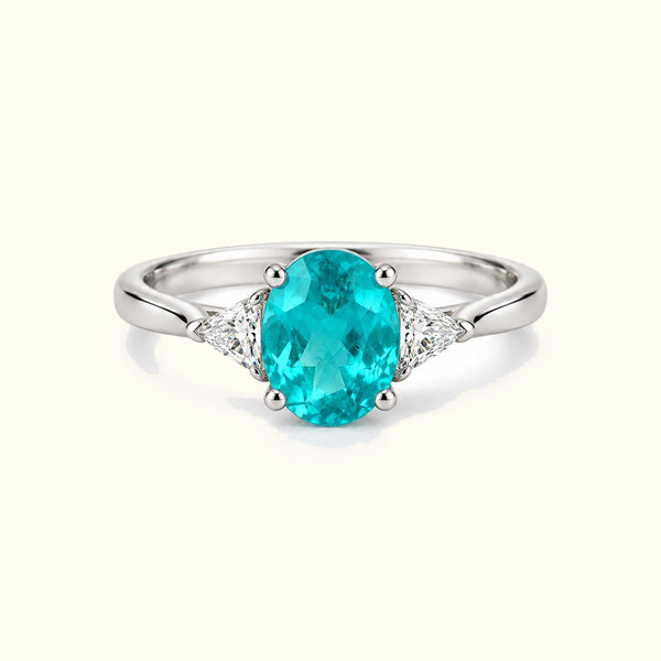 The Azure Paraiba Ring, an oval Paraiba tourmaline with trillion-cut diamonds in 18K white gold