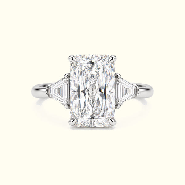 The Radiant, a radiant-cut lab-grown diamond ring with trapezoid side stones in polished platinum