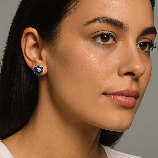 Lab-Grown Blue Sapphire & Diamond Flower Stud Earrings worn by a model, showcasing vibrant blue sapphires and a sparkling diamond.