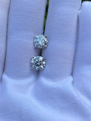 Lab-Grown Diamond Stud Earrings on a hand, showcasing their brilliance and precision-cut design.