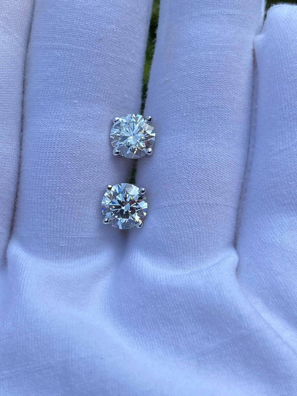 Lab-Grown Diamond Stud Earrings on a hand, showcasing their brilliance and precision-cut design.