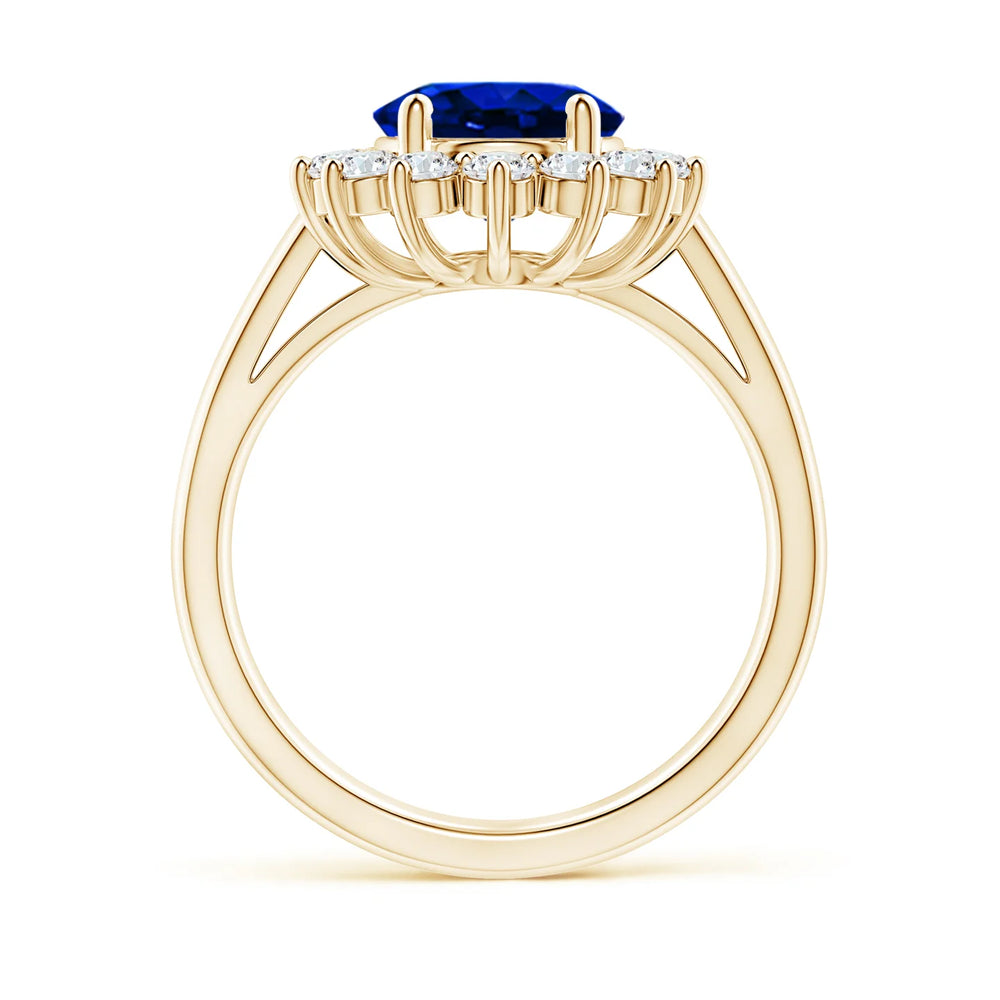 Lab-Grown Princess Diana Inspired Blue Sapphire Ring with Diamond Halo on a gold band.