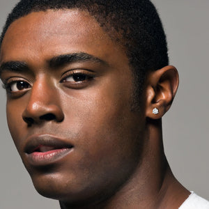 Young man wearing lab-grown diamond stud earrings, showcasing elegant jewelry essentials for any occasion.